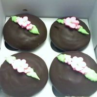 Chocolate Cupcakes With Ri Flowers Chocolate cupcakes with marshmellow cream filling covered in chocolate ganache with RI flowers/leaves on top. Thnx for looking!