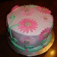 Daisies Everywhere I made this for my neice's birthday. Devils food cake, filled and iced with buttercream. Gumpaste daisies, fondant stems and swirls....