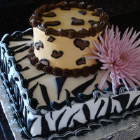 Animal Print Black & white cake with vanilla buttercream. Bottom was a 10" squre with the zebra print, and the top was a 6" round with the...