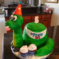 Dino-Mite 3-D dinosaur made for a little boy's 5th birthday. Cake was red velvet with vanilla vb. Covered with MMF and then airbrushed the color...