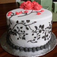 Black Scrollwork On White This is a test run on using a stencil. Black stencil work on white buttercream with red roses and buds