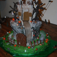 Castle Dracula Cake chocolate cake, chocolate castle,trees,fence,door,everything edible execpt trinketes on trees. thanks to the dvd from Susan Carberry.