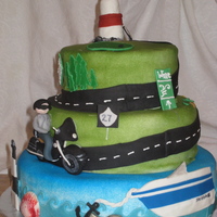 Long Island 50th Birthday cake - recipient wanted both boat and motorcycle theme. Bottom tier decorated with waves, shells, Robert Moses Lighthouse and...