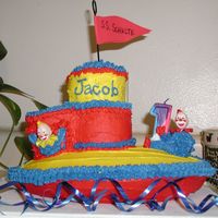 Tug Boat Cake For my son's 1st birthday. I used the Wilton football cake pan for the base.