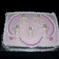 Baby Shower Cake - Girl Two-layer, yellow and chocolate, buttercream icing with royal icing flowers. Babies are made from rolled buttercream.