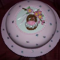 Pink Baby Shower Cake Cake is covered in fondant. Butter Pecan with vanilla/almond filling. The mouse and cradle are fondant. Flowers and plaque are gumpaste....