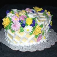 The Flowers Of Easter Egg shaped vanilla cake with lime curd filling. Iced with buttercream, decorated with royal icing flowers. The flowers were practice from...