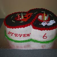 Img_6351.jpg Found the cake by Amyr and had to make it for my son's 6th birthday party. All chocolate with Vanilla BC. And hotwheels cars chosen by...