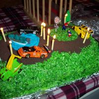 Race Track Picture Side Shot With Candles This is just another pic of the Race Track cake that I made for my step~son's 8th birthday. This one shows it all lit up with candles...