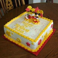 Mickey Mouse Birthday Chocolate cake w/buttercream/fondant accents. I usually don't like to put plastic centerpieces on cakes, but the mother bought it...