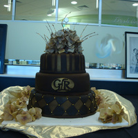 Dedication Ceremony 12, 9, 6, chocholate fondant with gold accents and silk hydrangea on top
