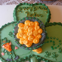 Parker's Birthday Cake Parker's birthday is on St. Patrick's day and she wanted a leprechaun and a pot of gold on her cake.All done in buttercream icing...
