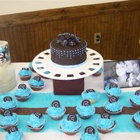 Sister's Baby Shower Cake yellow and chocolate cupcakes, with a 6-inch yellow cake to match. chocolate fontdant on cake and toppers for cupcakes. dots are royal,...