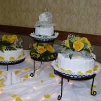 Wedding Cake W/fresh Yellow Roses White cake w/whipped cream frosting. So easy to work with. I've been taken classes in the cake decorating store and have made cakes...