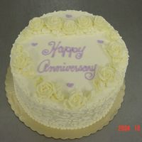 Anniversary Heart Of Roses Buttercream roses and leaves with scrolls on the side of the cake.