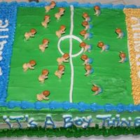 Football Baby Shower Cake This is a cake that I did for our youth football club's VP. I took plastic babies and added frosting diapers.