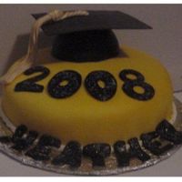 2008Gradcake.jpg Fondant covered cake with airbrushed fondant accents. Edible glitter was sprinkled on to the black numbers and letters while they were...