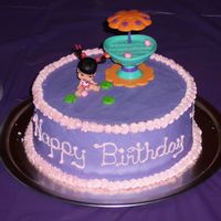 Bratz Cake This was for my daughters 8th birthday. I used an itsy bitsy bratz doll on the top, its frosted with buttercream.