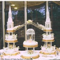 Marnelle's Cake chocolate mud cake - 4 tier steeple each and the gazebo has 2 tier with fondant icing. Roses handmade from sugar paste.
