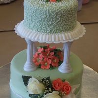 Wilton Course 3 Final Prjoect A tiered cake covered in fondant. The white roses in the front is a corsage that was given to me from my Mother-in-law, the peachy roses...