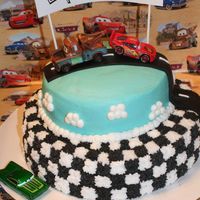 Disney Cars Birthday Cake. Chocolate bottom tier white white top tier. BC frosting with fondant road.