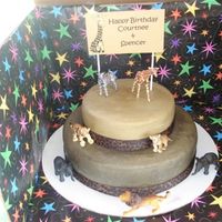 Safari Birthday Cake Top tier is white cake, bottom tier is chocolate, BC frosting with ribbon trim.