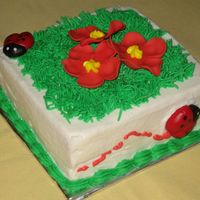 Ladybug And Flowers 4 in. white cake with BC. Ladybugs and flowers are fondant. This was the child's personal cake that went with the large ladybug cake...