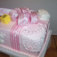 Pink Gift Box 8" square iced in BC with stripe bow to look like a gift, then added some BC baby decor on each side and top.