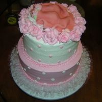 Twin Babies Fondant twins cuddled under a blanket on a bed of roses. top layer is white with pink dots and bottom is pink with white dots with ruffle...