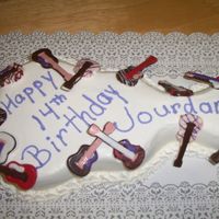 Guitar Birthday Made for my niece's 14th birthday. Used the Wilton guitar pan and made 14 individualchocolate guitars to decorate it with.