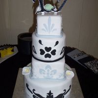 White/black/silver Wedding Cake Four tier wedding cake covered in fondant with fondant cutouts.