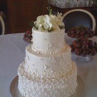 Blossom Wedding Cake All buttercream iced, with small 5-petal fondant cutout flowers to cover. This is a 12/9/6 cake - took approx. 450 flowers for this effect...