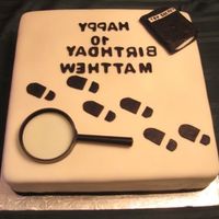 Secret Agent Cake Secret Agent CakeChocolate cake 14'. Fondant decorations with a real magnify glass.