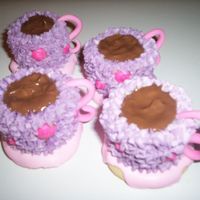 Teacups sugar cookie saucers, royal icing, butter cake iced in butter flavor buttercream, fondant handles, and poured chocolate! I did this for a...