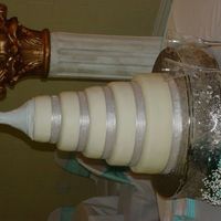 Sonya And Gilbert's Wedding 5 tier white cake with a strawberry creme filling covered in MMF, borders are covered with silver ribbon