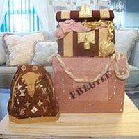 1480230159_6331A28D88_M1.jpg Fondant covered cakes with gumpaste "jewelry". Hand painted "LV" logo...next time I will create and use a stencil!