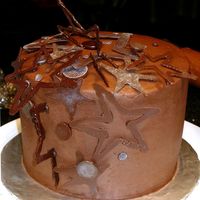 Birthday Stars 6" round, 6" high - chocolate buttercream with dark and light chocolate candy melts dusted with pearl dust