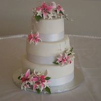 My First Wedding Cake Cake sizes: 10,8,6french vanilla cake with buttercream filling, covered in fondant withgumpast stargazer lillies. this turned out to be way...