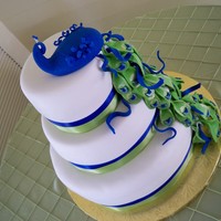 Peacock hand maid peacock and tail from gum paste and fondant. hand painted gold accents