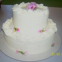 103_1244-2-1-11_Small.jpg Vanilla Pound Cake with Vanilla Buttercream filling and frosting. Accented with petite petunias. (several of the flowers blew away in the...