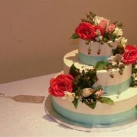 P10007951_Small.jpeg Another view... this vanilla/almond pound cake was covered in vanilla buttercream, a stunning variety of fresh flowers, greenery, rose hips...