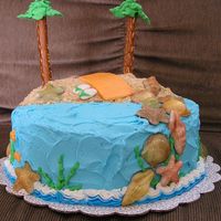 A Day At The Beach All buttercream except for the fondant beach towel and sandals. The seashells are white chocolate that I dusted with luster dust.