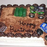 Monster Truck Madness This cake was a hot mess. Sprayed the cars with green and built the ramps with RKT and BC. Used Cocoa and Brown Sugar for the dirt and choc...