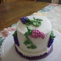 Bunches Of Grapes Vanilla butter cake with Raspberry filling (6"); BC icing and decoration for a wine lover's birthday at home with her hubby....