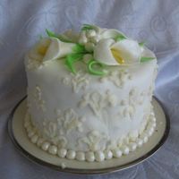 Calla Lily Cake Ii Almond cake filled with raspberry and apricot preserves, covered in almond buttercream and marshmallow fondant. The pearls and drapes are...