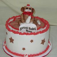 Sock Monkey This is a baby shower cake. I am happy with the way it came out. The monkey is fondant as are the other decorations.