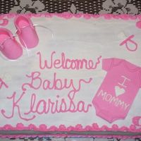 Baby Shower bc w/fondant booties and onsie. banana cake w/strawberry filling.