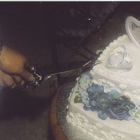 Damian & Michelles Wedding Cake Simple stacked heart shaped wedding cake with blue/purple flowers separating the layers