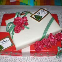 Mom's & Marc's Bday/ Christmas Cake I used MMF to wrap the gifts in. I made the roses out of gum paste, which took me sometime to learn but finally got it.