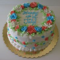 4Th Of July Cake For a beach picnic. Dk. Chocolate cake, layered with red, white, and blue BC, decorated with BC and fondant flowers. TFL.